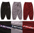 A BATHING APE COLOR CAMO DEFORMATION LOOSE FIT TRACK PANTS